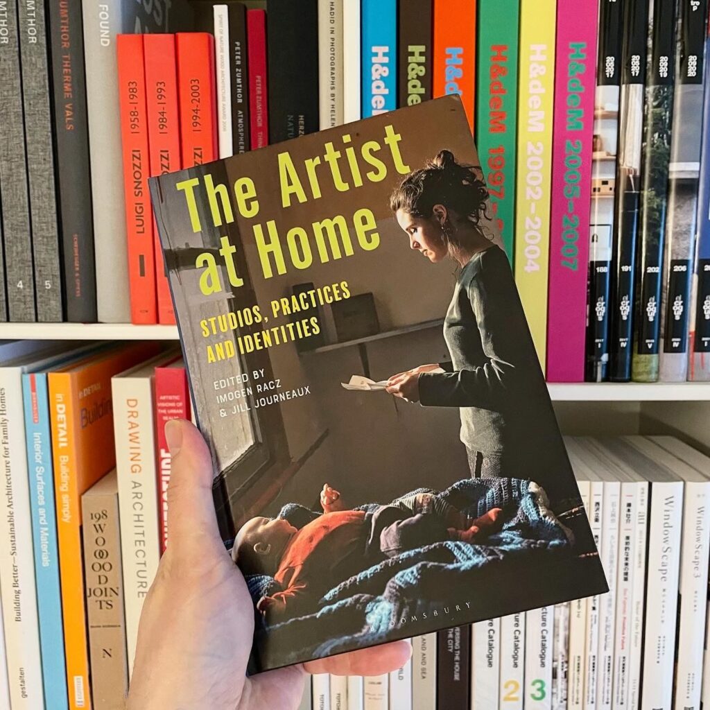 Forsiden af bogen The Artist at Home, hvor en person ses med et brev i hånden og en baby ligger ved siden af.